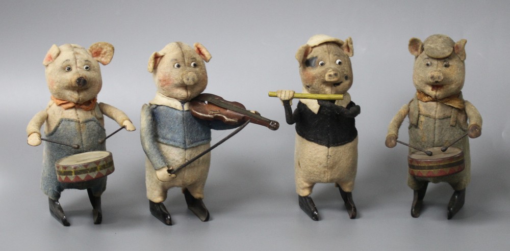 A set of four Schuco clockwork tinplate musical pigs, height 11cm